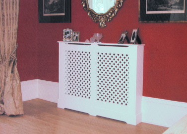 Radiator cover with a double panel painted cover with a painted single overlaid lattice. This radiator cover hides an unsightly radiator in an otherwise elegant room.